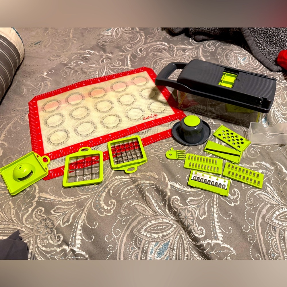 Two Silicon baking sheets, along with a chopper and all of its accessories